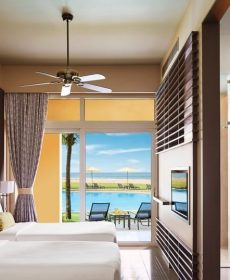 Deluxe Bedroom with a view of the ocean across pool in Negombo