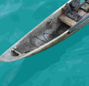 Wooden canoe filled with mystic masks on calm turquoise water. Experience Islandwyde’s Romantic escape sri lanka holiday packages experiences
